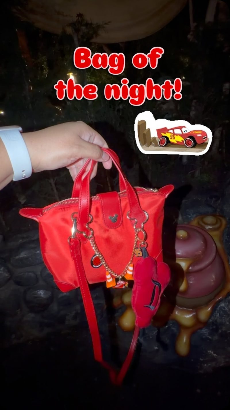 Race car themed purse chain on a red bag